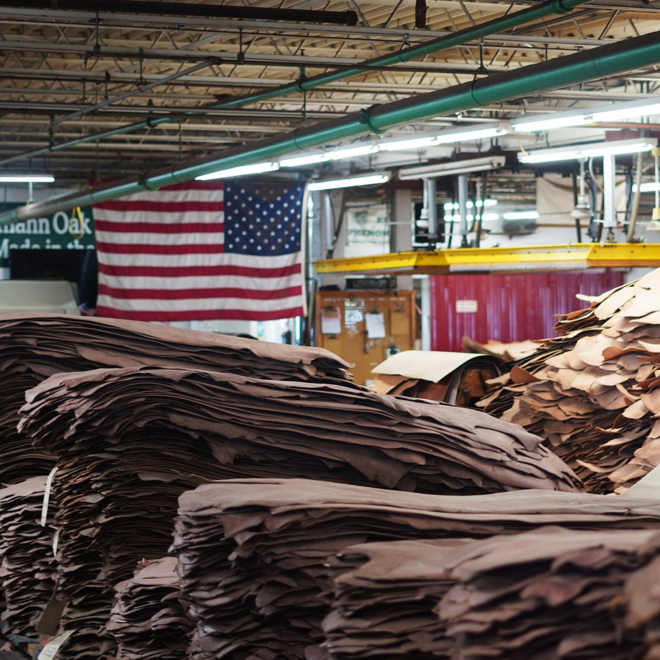 A leather tannery in the US with a large American flag 