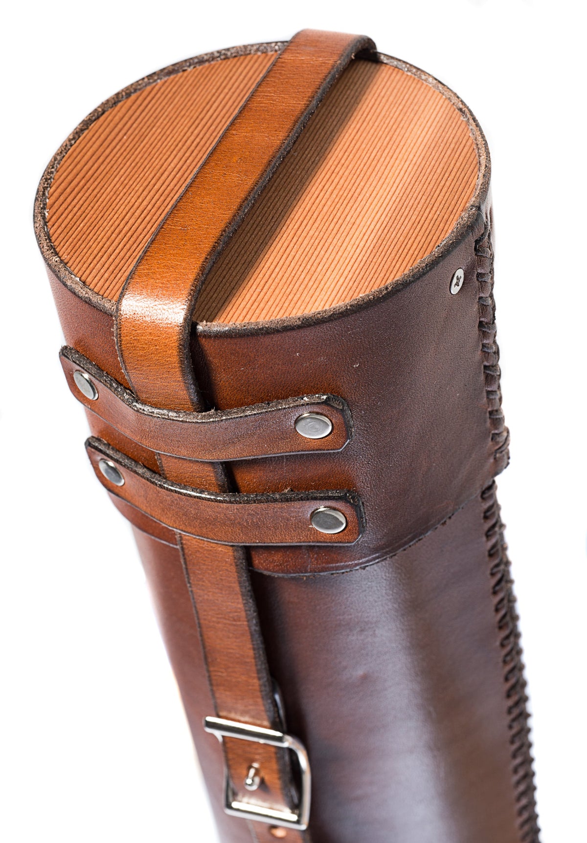 Top end of a dark brown leather document tube shown close-up, highlighting the cedar wood end cap