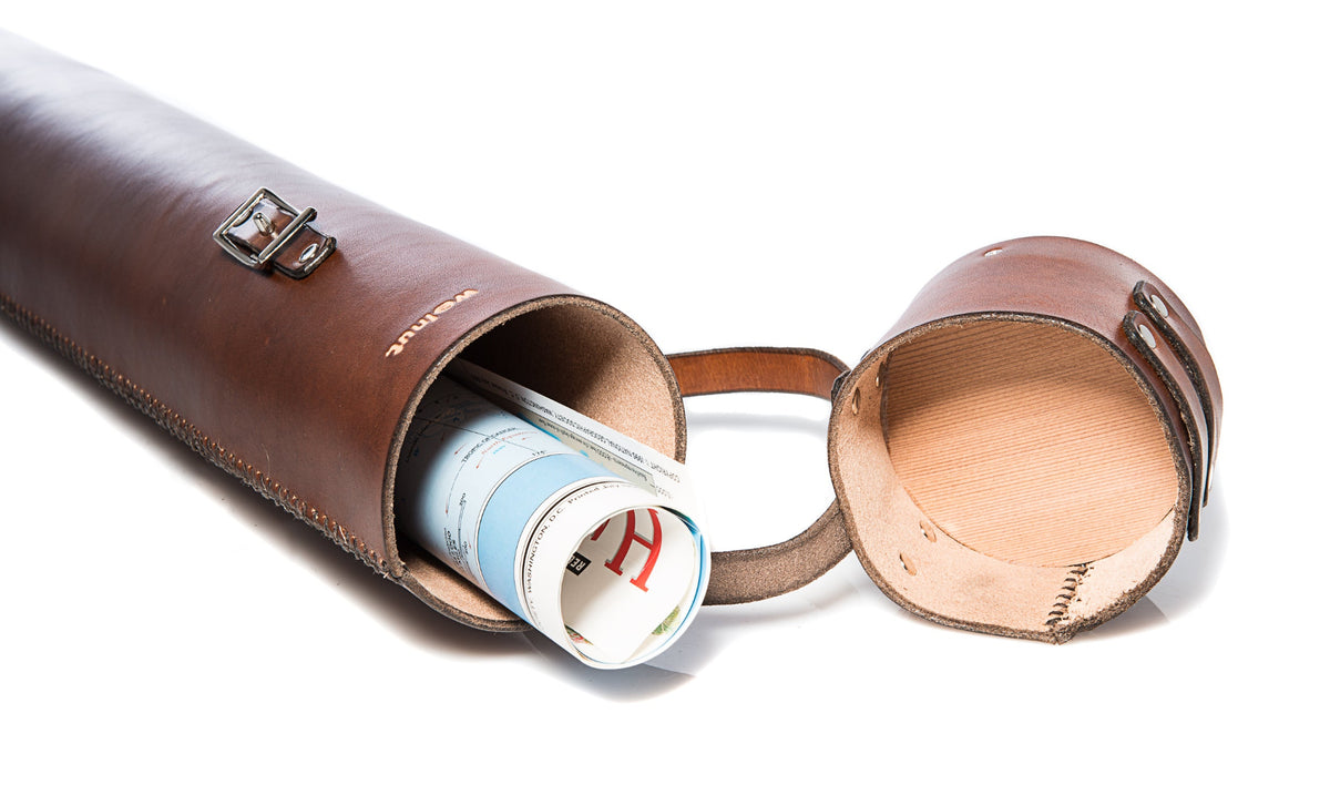 Brown leather tubular document case with a rolled-up map inside on a white background, showing the underside of the cedar wood lid