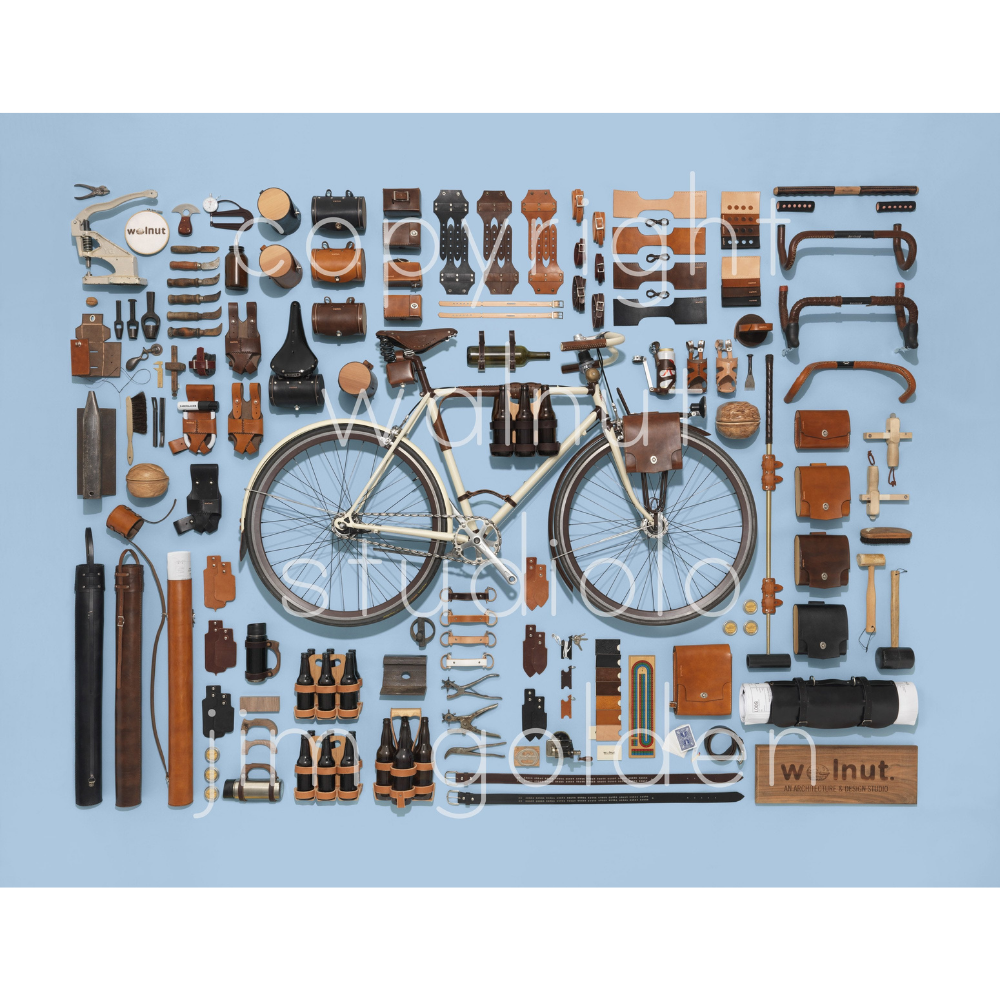 A close-up of the leather bicycle accessories with a "walnut studiolo jim golden" watermark
