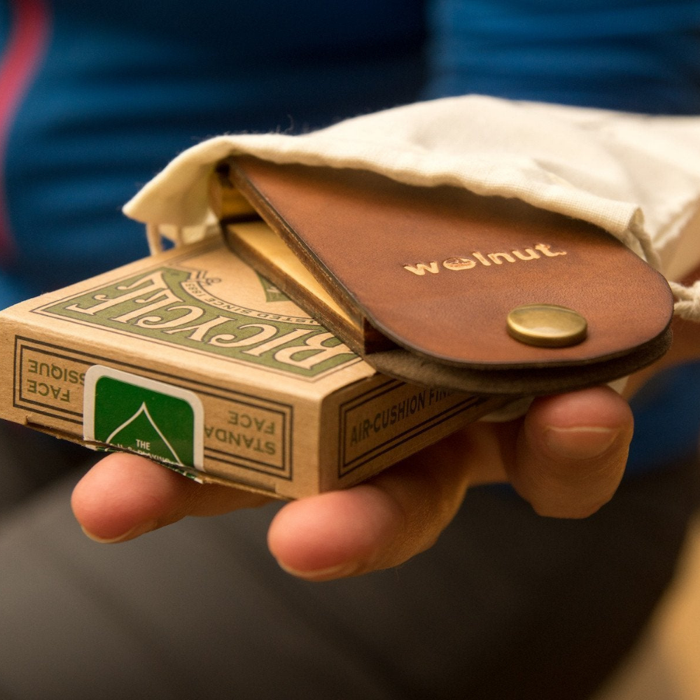 Hand holding gift set and deck of cards for scale